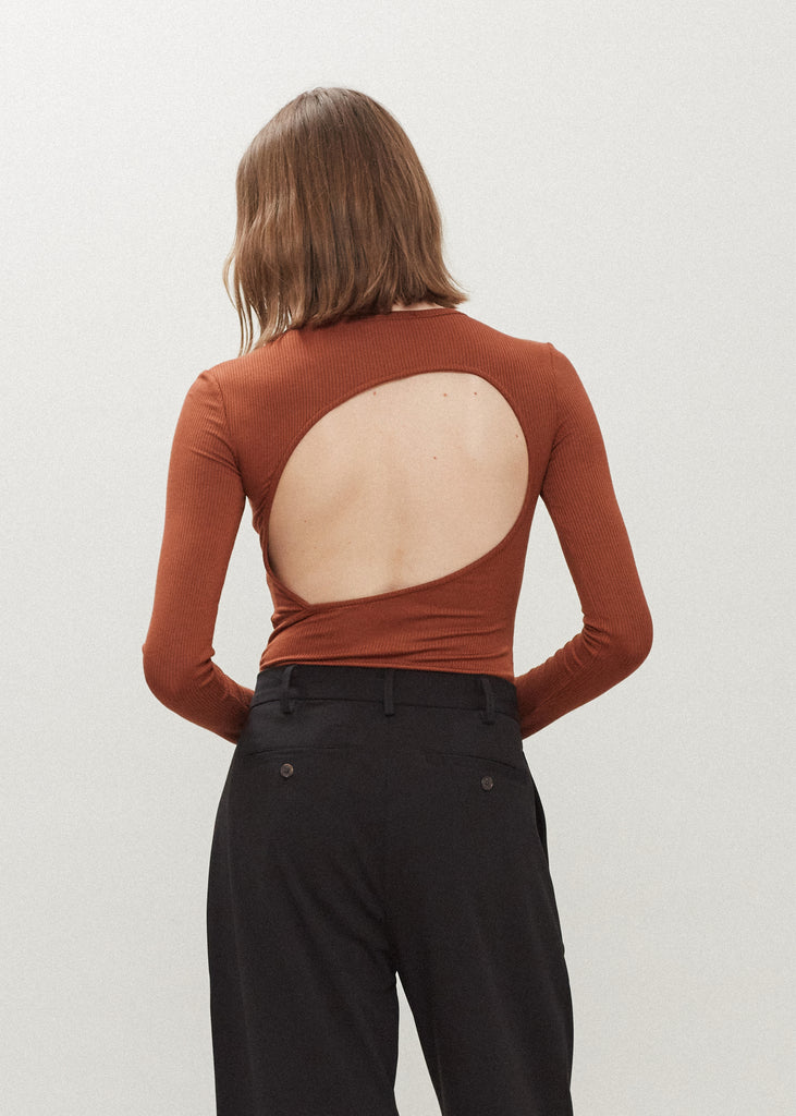 Pecan Baby Bodysuit This buttery soft long sleeved bodysuit features a sleek silhouette with a crew neckline and an asymmetrical bold back cutout. *For sanitary reasons, bodysuits are finale sale.