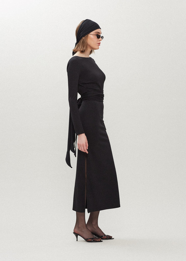 Black Bambi Dress This wrap dress features a fixed belt at waist and plunging open back. Crafted from a stretch ponte fabric, hidden zips at sides provide option to vent. Size down for a snug fit.Styled with The Jamie WrapAlso available in Bone & Lime Punch featured in Collection 1.
