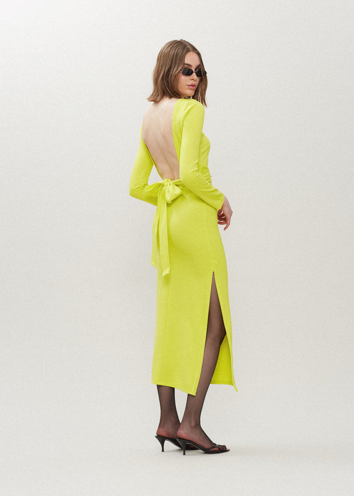Lime Punch Bambi Dress | The Archive This wrap dress features a fixed belt at waist and plunging open back. Crafted from a stretch ponte fabric, hidden zips at sides provide option to vent. Size down for a snug fit.All items within The Archive Collection are FINAL SALE. 