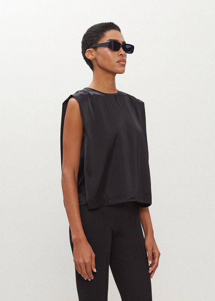 Black Brooke Tank Crafted from luxurious vegan silk, this muscle tee is complete with high curved neckline, shoulder-width sleeves, and a relaxed boxy shape.  FINAL SALE - EXCHANGE OR STORE CREDIT ONLY