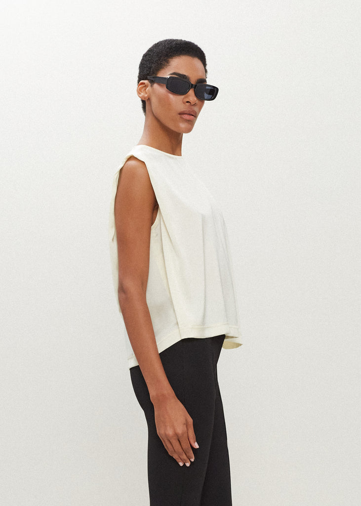 Bone Brooke Tank Crafted from luxurious vegan silk, this muscle tee is complete with high curved neckline, shoulder-width sleeves, and a relaxed boxy shape.*Sale merchandise is exchangeable for size or store credit. 