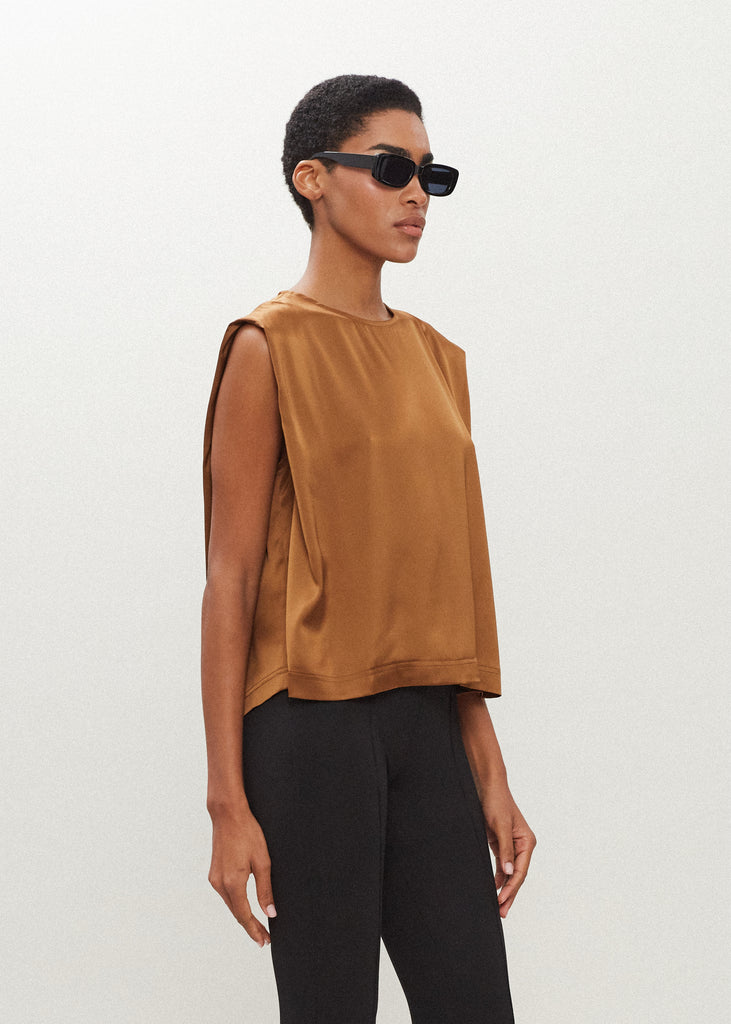 Cinnamon Brooke Tank Crafted from luxurious vegan silk, this muscle tee is complete with high curved neckline, shoulder-width sleeves, and a relaxed boxy shape.  FINAL SALE - EXCHANGE OR STORE CREDIT ONLY
