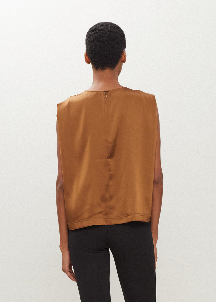 Cinnamon Brooke Tank Crafted from luxurious vegan silk, this muscle tee is complete with high curved neckline, shoulder-width sleeves, and a relaxed boxy shape.  FINAL SALE - EXCHANGE OR STORE CREDIT ONLY
