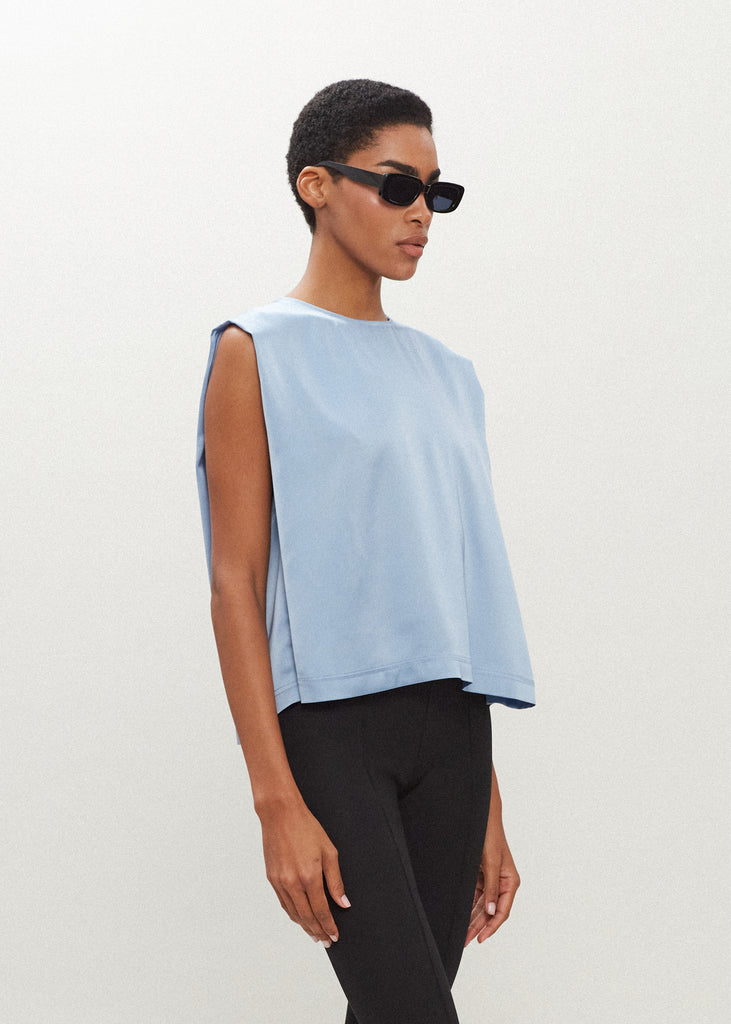 Sky Brooke Tank Crafted from luxurious vegan silk, this muscle tee is complete with high curved neckline, shoulder-width sleeves, and a relaxed boxy shape.  FINAL SALE - EXCHANGE OR STORE CREDIT ONLY