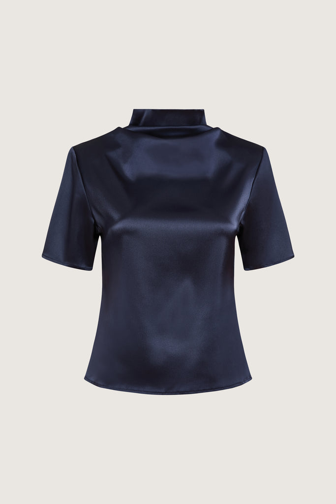 Navy Vivien Top -Cowl neckline with stacked collar-Self-loop and gold knot button at back neck-Removable shoulder pads with interior pockets-French seams for clean finish-1/4” baby hem on sleeves and body-Fluid drape with tailored structure Cara is 5'10