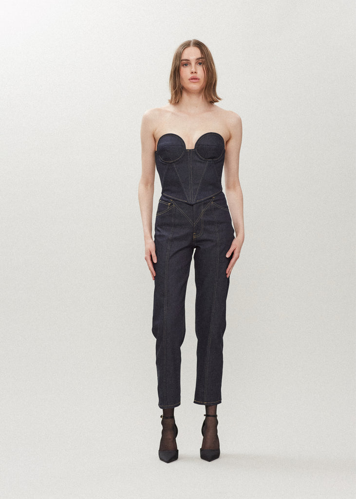 Raw Indigo Chloe Corset This strapless corset features a fitted lightweight denim bodice with contoured boning, moldable wiring at cups, and shirred back panels to ensure a snug yet flexible fit. Slightly cropped with a v-front silhouette.Styled with The Sarah Stretch Jean | The Sasha Stretch Bolero