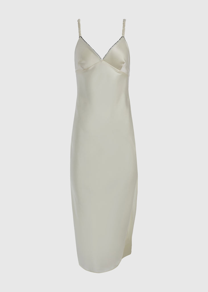 Bone Paras Dress The Paras vegan silk midi slip dress features a v-neckline with scalloped trim, bust darts, ruched elastic straps, a low cut open back, and a curved, vented hemline.SALE MERCHANDISE IS EXCHANGE OR STORE CREDIT ONLY
