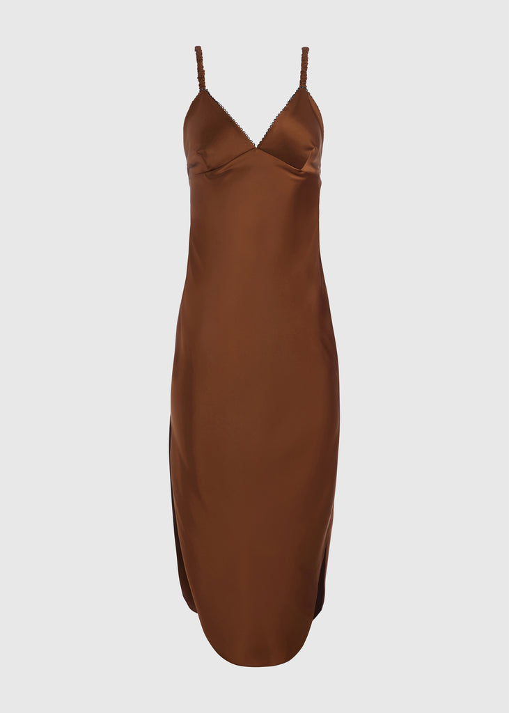 Cinnamon Paras Dress | The Archive The Paras vegan silk midi slip dress features a v-neckline with scalloped trim, bust darts, ruched elastic straps, a low cut open back, and a curved, vented hemline.All items within The Archive Collection are FINAL SALE.Subscribe to our newsletter to unlock an additional offer exclusive to the archive sale.