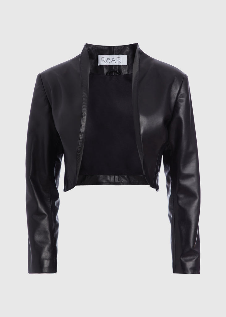 Black Saint Bolero | The Archive This cropped bolero-style jacket is cut from luxurious Italian leather. It features an open front, internal zip-pocket, and shoulder pads for added structure.All items within The Archive Collection are FINAL SALE.Subscribe to our newsletter to unlock an additional offer exclusive to the archive sale.