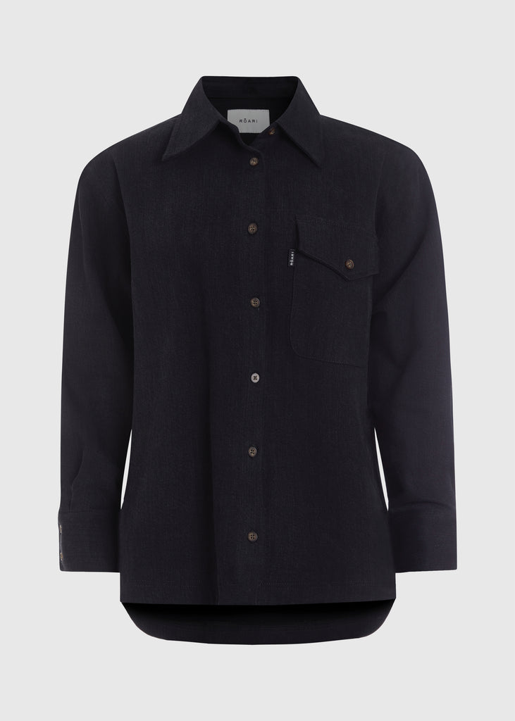 Jet Black Charlie Shirt This oversized button down is crafted from lightweight denim for a drapey yet structured silhouette. Its relaxed fit is finished with traditional denim stitching and horn buttons. Features a RŌARI branded deco label at chest pocket.