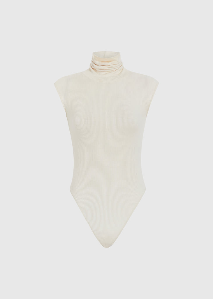 Bone Penny Bodysuit This buttery soft sleeveless ribbed turtleneck bodysuit showcases a sleek silhouette for a versatile wardrobe staple.Styled with The Kat Trouser | The Duke JoggerFINAL SALE 
