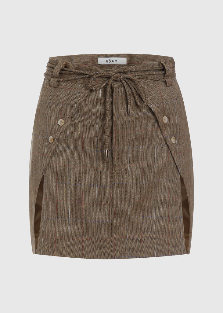 Camel Herringbone Ronnie Skirt | The Archive Paneled skirt featuring a self-fabric waist tie tunneled through two rows of belt loops. Double front vents are secured by horn buttons. Slightly lengthened back for added coverage.Styled with The Ronnie Blazer | The Ronnie CorsetAll items within The Archive Collection are FINAL SALE.Subscribe to our newsletter to unlock an additional offer exclusive to the archive sale.