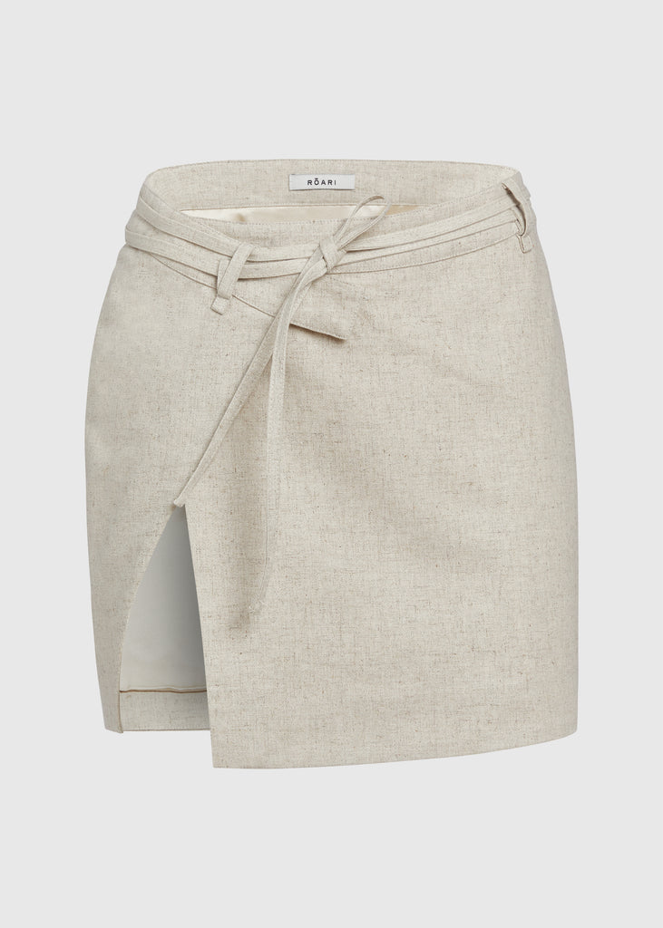 Oatmeal Louise Skirt This linen wrap mini skirt features an asymmetrical waistband and flattering cutout at the thigh.Styled with The Louise Top