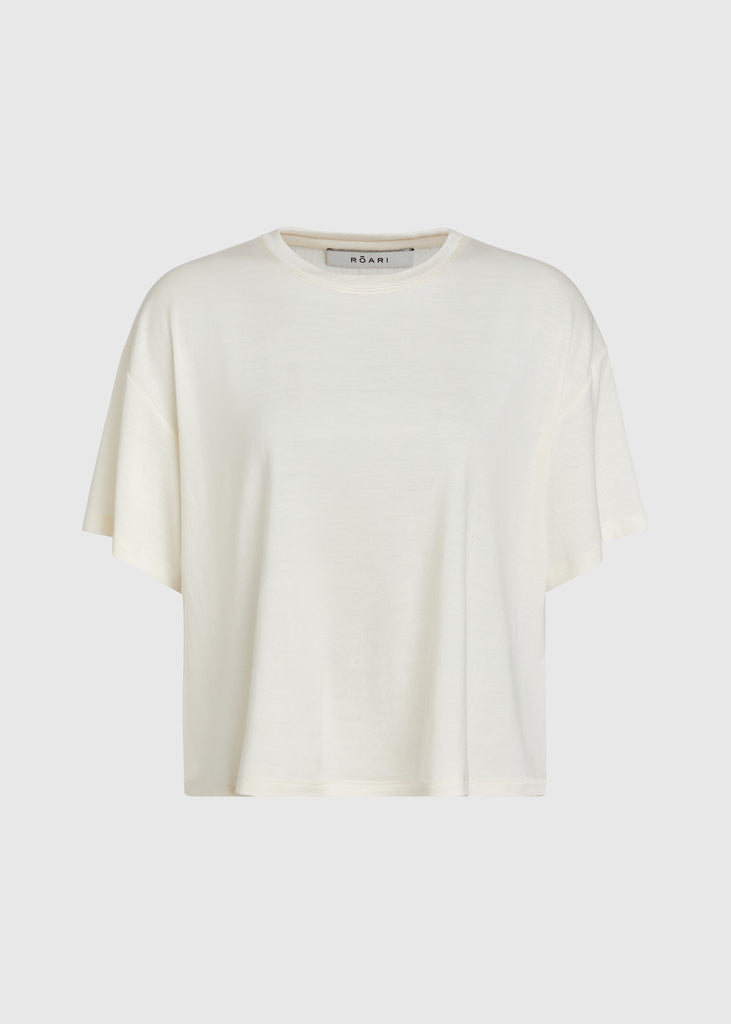 Bone Zoey Tee This tee crafted from premium merino wool features an oversized relaxed silhouette and a lightly sheer finish. 