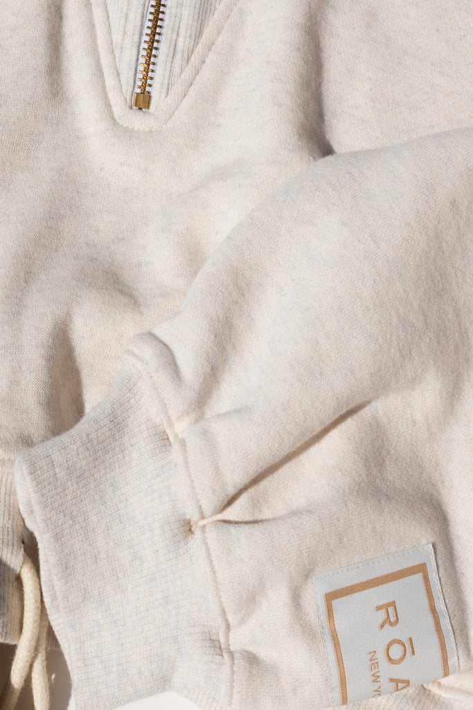 Oatmeal Duke Sweatshirt This branded pre-shrunk half-zip sweatshirt features a relaxed, cropped fit and draw cord at waist for option to cinch.Style with The Duke Jogger