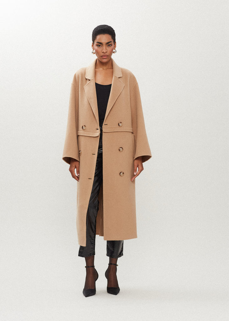 Camel Evelyn Coat This convertible coat features a low double breasted front with horn buttons and dropped shoulders. Purposefully designed oversized to allow for comfortable layering. Zipper above welt side pockets allows to double as a cropped jacket. 