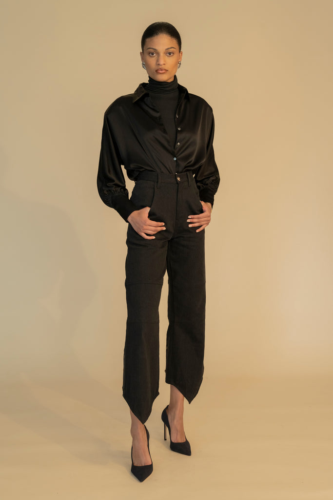 Black MARNA SHIRT A silky button down featuring blouson sleeves. Composed of wrinkle resistant vegan silk, this top includes mother of pearl buttons, concealed zippers at wrists, and removable shoulder pads.  