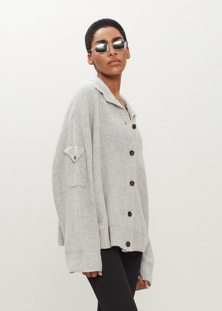 Heather Grey Graham Cardigan This 100% royal cashmere cardigan features an oversized silhouette that hits below the hip, perfect for layering. Features horn buttons along with pockets at chest and right sleeve. Can be worn open or buttoned up as a turtleneck.
