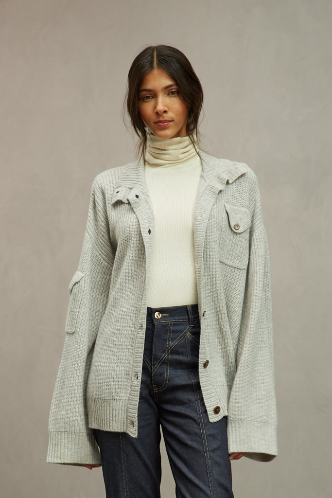 Heather Grey Graham Cardigan This 100% royal cashmere cardigan features an oversized silhouette that hits below the hip, perfect for layering. Features horn buttons along with pockets at chest and right sleeve. Can be worn open or buttoned up as a turtleneck.