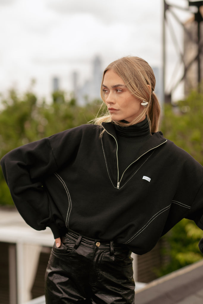 Black Archive / Henry Sweatshirt This half-zip pullover features a ribbed v-neckline, branded patch logo and side pockets. Styled with The Penny Bodysuit | The Ashley Pant *Please reference our return & exchange policy for Sale & Archived items.