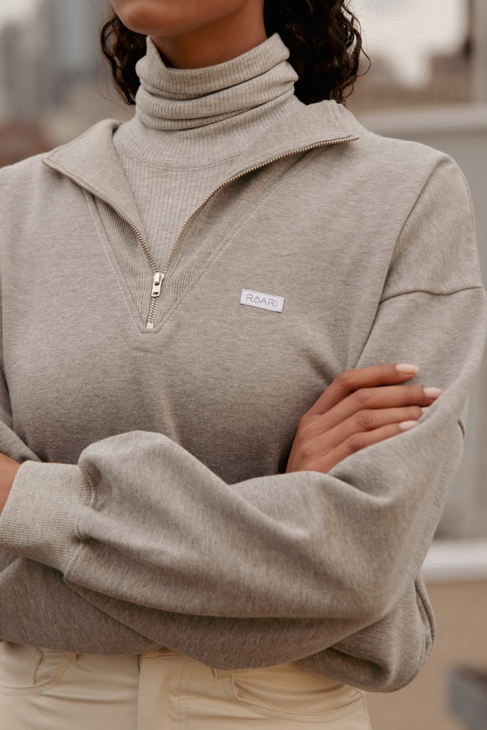 Heather Grey Archive / Henry Sweatshirt This half-zip pullover features a ribbed v-neckline, branded patch logo and side pockets. Styled with The Penny Bodysuit | The Ashley Pant *Please reference our return & exchange policy for Sale & Archived items.