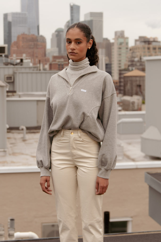 Heather Grey Archive / Henry Sweatshirt This half-zip pullover features a ribbed v-neckline, branded patch logo and side pockets. Styled with The Penny Bodysuit | The Ashley Pant *Please reference our return & exchange policy for Sale & Archived items.