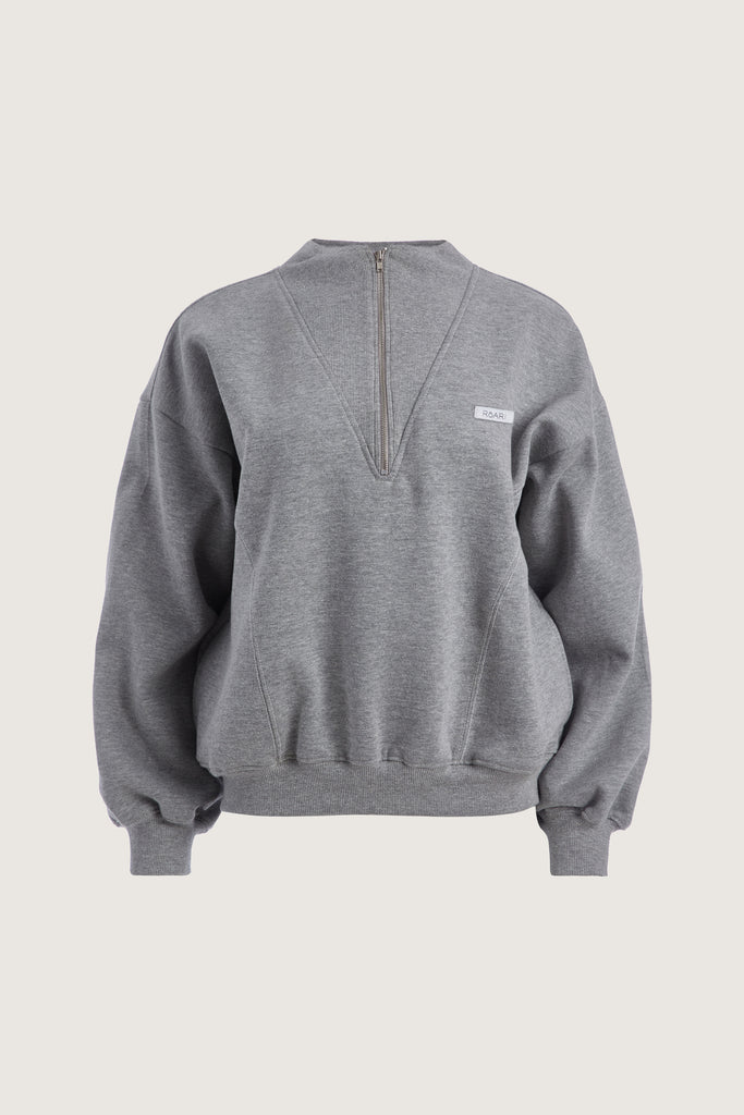 Heather Grey Henry Sweatshirt This half-zip pullover features a ribbed v-neckline, branded patch logo and side pockets. This item is FINAL SALE.