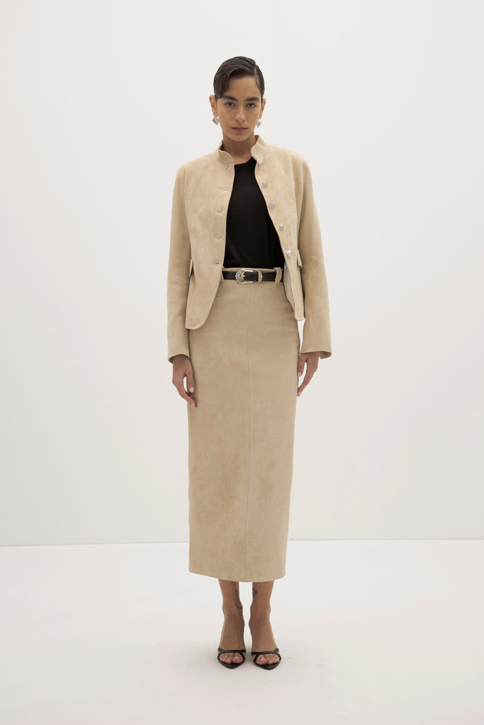 Sand Meredith Skirt -Vintage inspired pencil skirt, fitted through waist and hips-100% calf leather (suede) -Darts at front and back for a sculpted fit-Clean-finished waistband with interior facing and under-stitching-Invisible side zipper with ornate button closure at waistband-Self-doubled belt loops reinforced with strong bar tacks-Back vent for movement -Fully lined Ingryd is 5'10