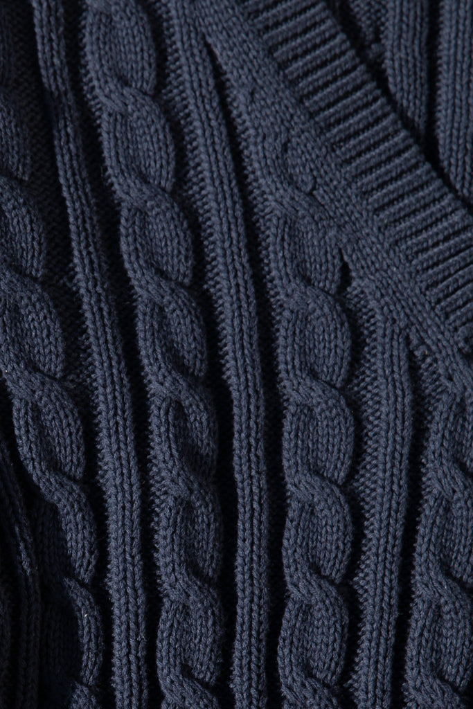 Navy Isabel Sweater Made with 100% cotton yarn, this convertible cable knit sweater features hidden snaps for the option to remove the sleeves. Knit draw cord at waist for choice to cinch or neatly tuck into your favorite jeans. A quintessential seasonless piece.*The top left and right of the removable sleeves will have either a red or white small sewn on marker, indicating which sleeve goes where for ease when placing back on.Styled with The Marna Poplin Shirt | The Kat Trouser *Please reference our return & exchange policy for Sale & Archived items.