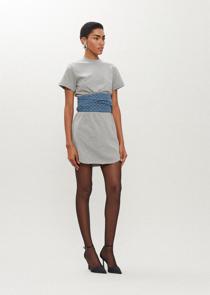 Heather Grey Lea Dress Crafted from premium cotton, this crew neck t-shirt dress boasts a curved hemline. Finished with attached denim studded belt. *Sale merchandise is exchangeable for size/color or store credit. 
