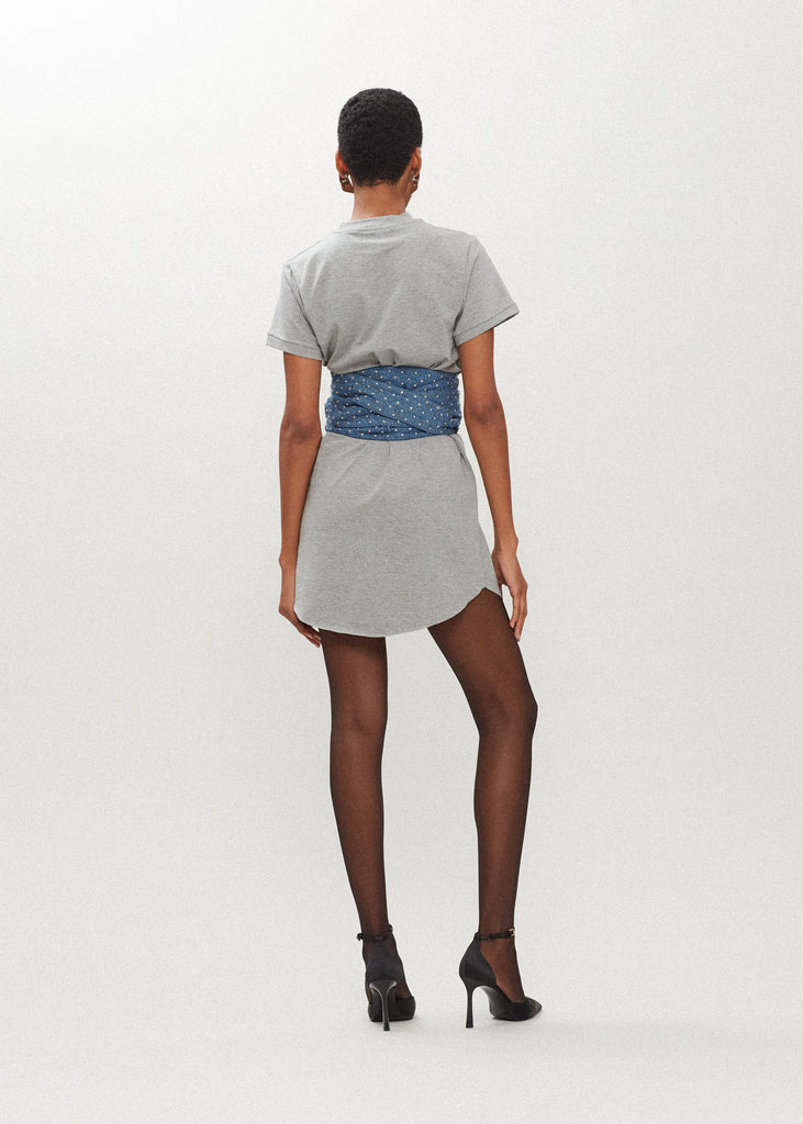 Heather Grey Lea Dress Crafted from premium cotton, this crew neck t-shirt dress boasts a curved hemline. Finished with attached denim studded belt. *Sale merchandise is exchangeable for size/color or store credit. 