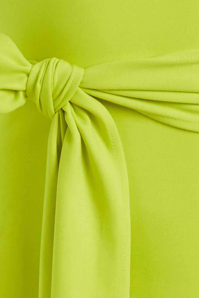 Lime Punch Bambi Dress This wrap dress features a fixed belt at waist and plunging open back. Crafted from a stretch ponte fabric, hidden zips at sides provide option to vent. Size down for a snug fit.All items marked down are FINAL SALE. 