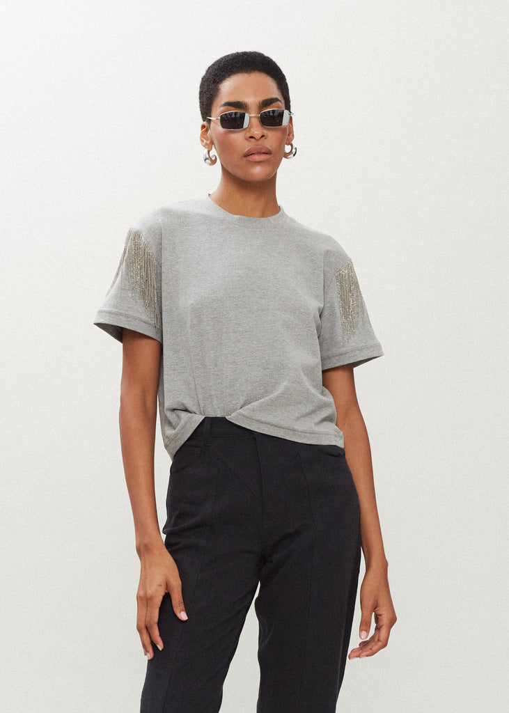 Heather Grey Liz Tee The Liz Tee is crafted from 100% premium stretch cotton and designed with a boxy cut crewneck for a contemporary look. Hand-applied silver chain fringe detail at the shoulders and a cropped fit that sits perfectly above the hip.*Sale merchandise is exchangeable for size/color or store credit. 