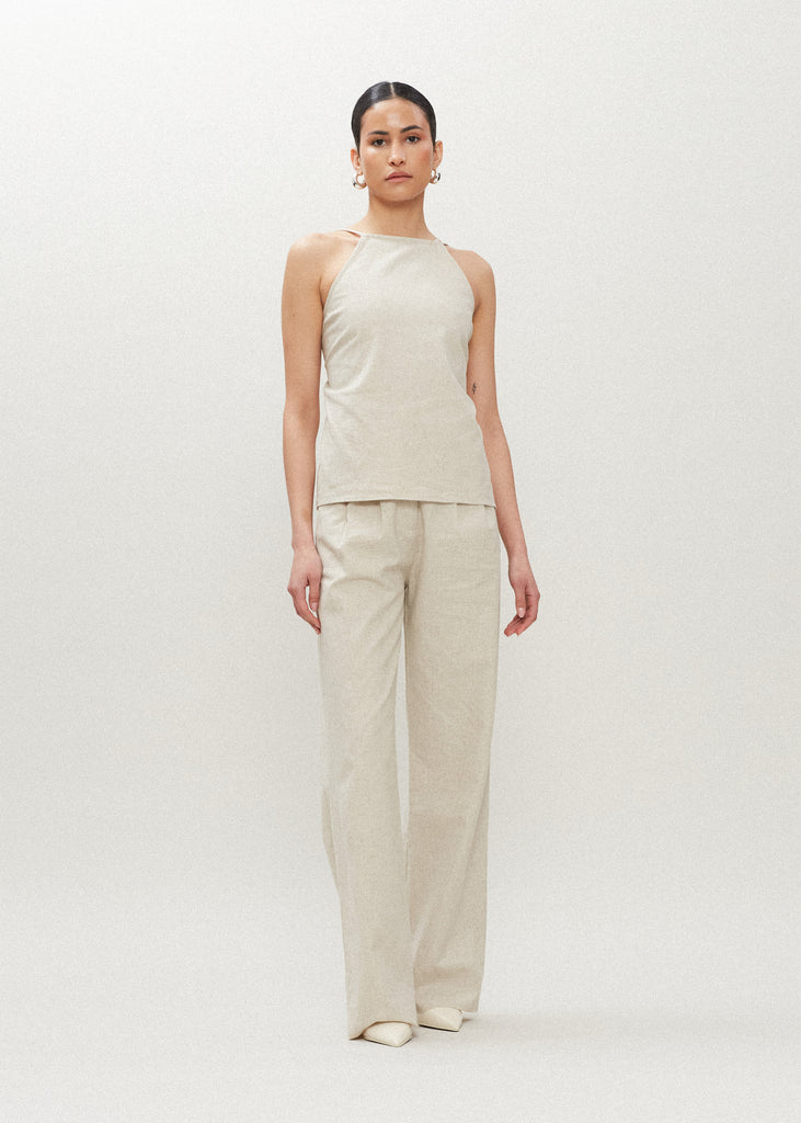 Oatmeal Louise Top This linen square neck top is constructed from a flax linen and cotton blend. It features an open back offering ROARI's signature statement- an arrangement of ways to be tied.Styled with The Louise Trouser | The Louise Shirt | The Louise Skirt