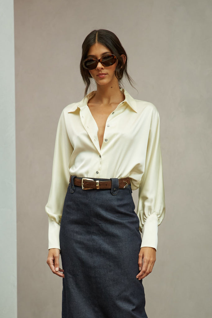 Bone Marna Shirt A silky button down featuring blouson sleeves. Composed of wrinkle resistant vegan silk, this top includes mother of pearl buttons, concealed zippers at wrists, and removable shoulder pads. All items marked down are FINAL SALE.