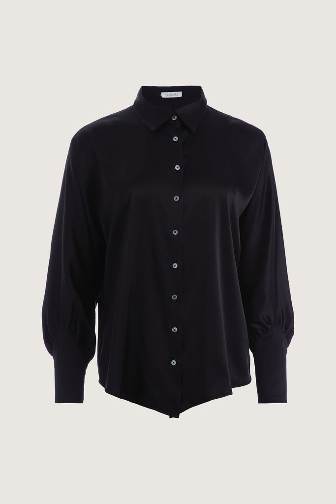 Black Marna Shirt A silky button down featuring blouson sleeves. Composed of wrinkle resistant vegan silk, this top includes mother of pearl buttons, concealed zippers at wrists, and removable shoulder pads. 