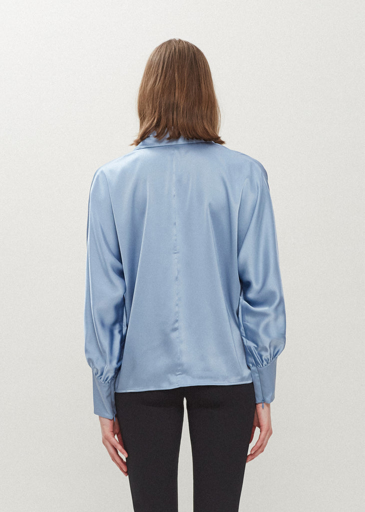 Sky Marna Shirt Made with vegan silk, this button-down shirt features blouson sleeves and concealed zippers at the wrist. It includes removable shoulder pads, mother of pearl buttons, and is wrinkle-resistant.*Sale merchandise is exchangeable for size/color or store credit. 