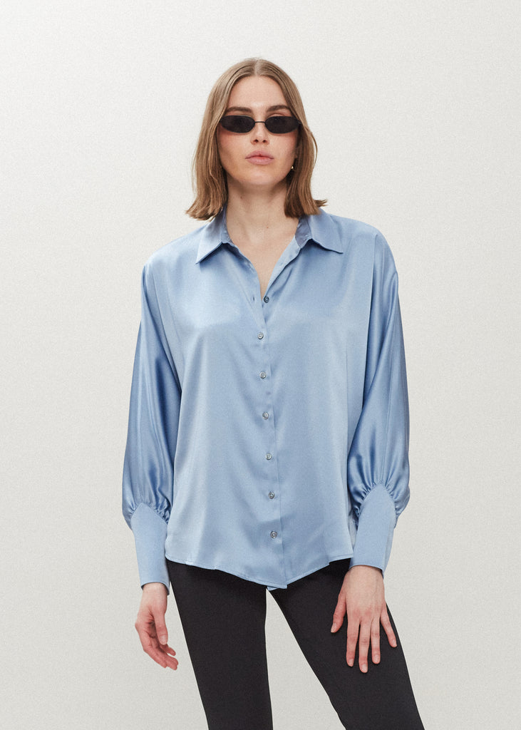Sky Marna Shirt Made with vegan silk, this button-down shirt features blouson sleeves and concealed zippers at the wrist. It includes removable shoulder pads, mother of pearl buttons, and is wrinkle-resistant.*Sale merchandise is exchangeable for size/color or store credit. 