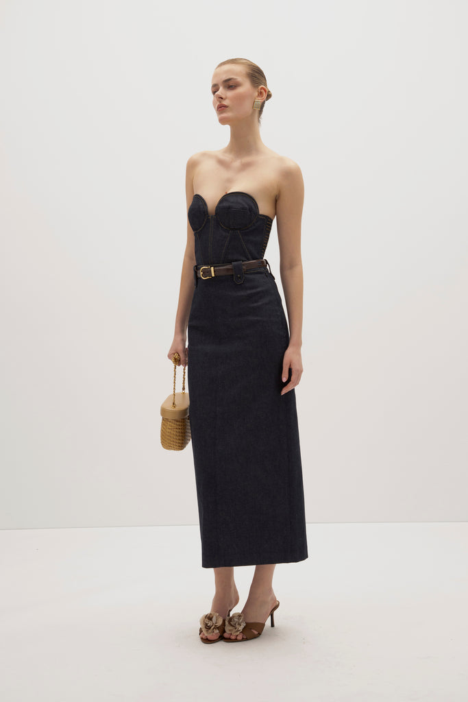 Raw Indigo Meredith Denim Skirt -Vintage inspired pencil skirt, fitted through waist and hips-Darts at front and back for a sculpted fit-Clean-finished waistband with interior facing and under-stitching-Invisible side zipper with button closure at waistband-Self-doubled belt loops reinforced with strong bar tacks-Back vent for movement -Fully lined Cara is 5'10