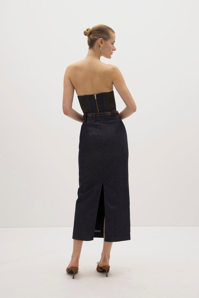 Raw Indigo Meredith Denim Skirt -Vintage inspired pencil skirt, fitted through waist and hips-Darts at front and back for a sculpted fit-Clean-finished waistband with interior facing and under-stitching-Invisible side zipper with button closure at waistband-Self-doubled belt loops reinforced with strong bar tacks-Back vent for movement -Fully lined Cara is 5'10