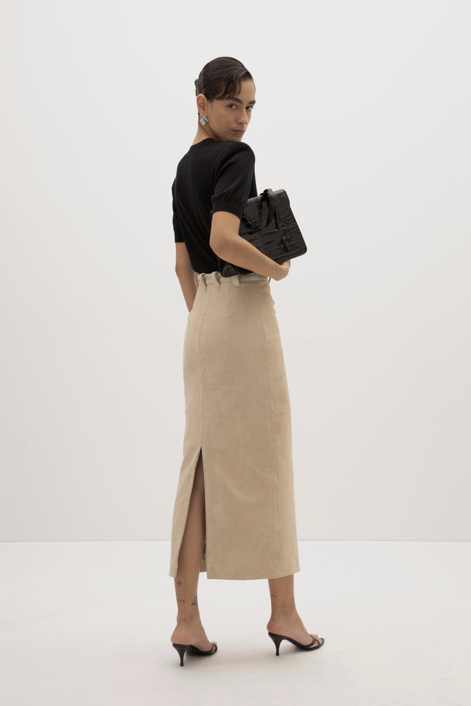 Sand Meredith Skirt -Vintage inspired pencil skirt, fitted through waist and hips-100% calf leather (suede) -Darts at front and back for a sculpted fit-Clean-finished waistband with interior facing and under-stitching-Invisible side zipper with ornate button closure at waistband-Self-doubled belt loops reinforced with strong bar tacks-Back vent for movement -Fully lined Ingryd is 5'10