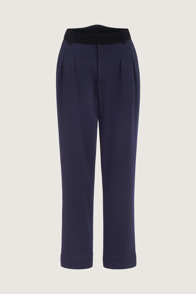 Navy Herringbone Meredith Trouser A fresh take on the classic straight leg suit pant, these trousers are crafted with fine Italian virgin wool. Detailed contrasting velvet at waist. Lined. Includes a release at the bottom hem for added length if desired. Molly is 5’9” and wearing a size 23.Styled with The Meredith Jacket | The Meredith Coat.