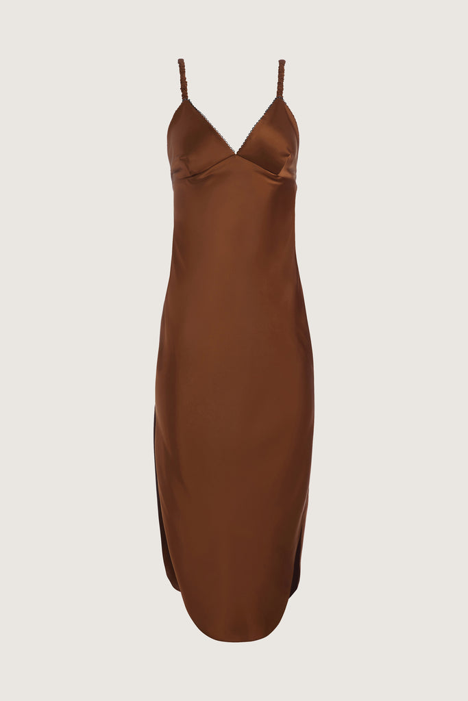 Cinnamon Paras Dress The Paras vegan silk midi slip dress features a v-neckline with scalloped trim, bust darts, ruched elastic straps, a low cut open back, and a curved, vented hemline.All items marked down are FINAL SALE.