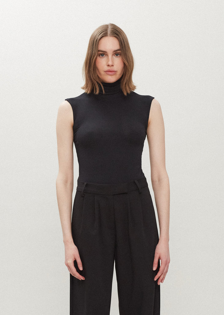 Black Penny Bodysuit This buttery soft sleeveless ribbed turtleneck bodysuit showcases a sleek silhouette for a versatile wardrobe staple. *For sanitary reasons, bodysuits are finale sale.