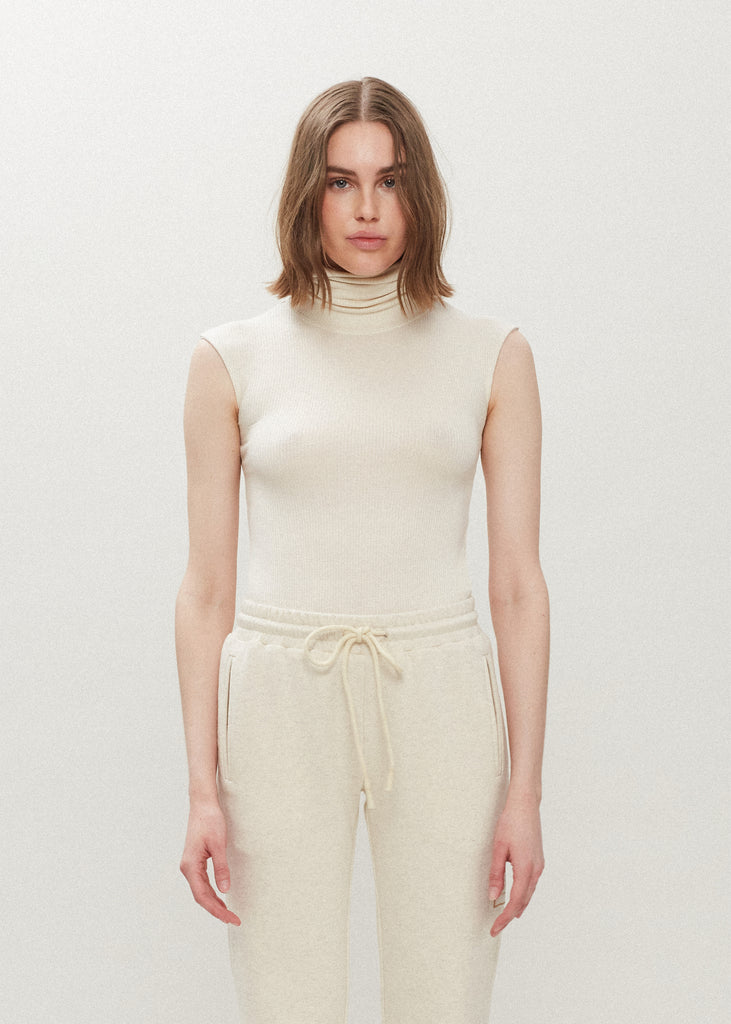 Bone Penny Bodysuit This buttery soft sleeveless ribbed turtleneck bodysuit showcases a sleek silhouette for a versatile wardrobe staple. *For sanitary reasons, bodysuits are finale sale.