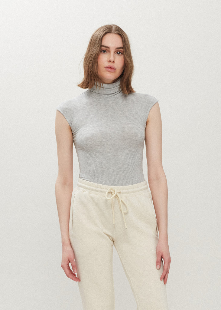 Light Grey Penny Bodysuit This buttery soft sleeveless ribbed turtleneck bodysuit showcases a sleek silhouette for a versatile wardrobe staple. *For sanitary reasons, bodysuits are finale sale.