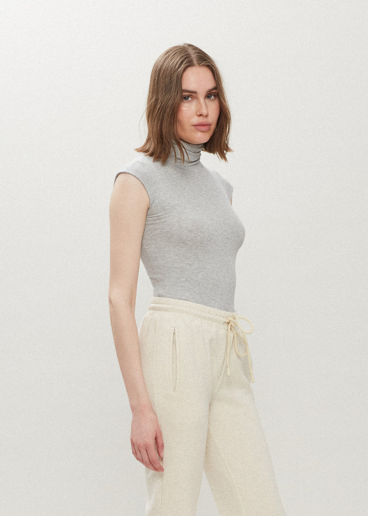 Light Grey Penny Bodysuit This buttery soft sleeveless ribbed turtleneck bodysuit showcases a sleek silhouette for a versatile wardrobe staple. *For sanitary reasons, bodysuits are finale sale.