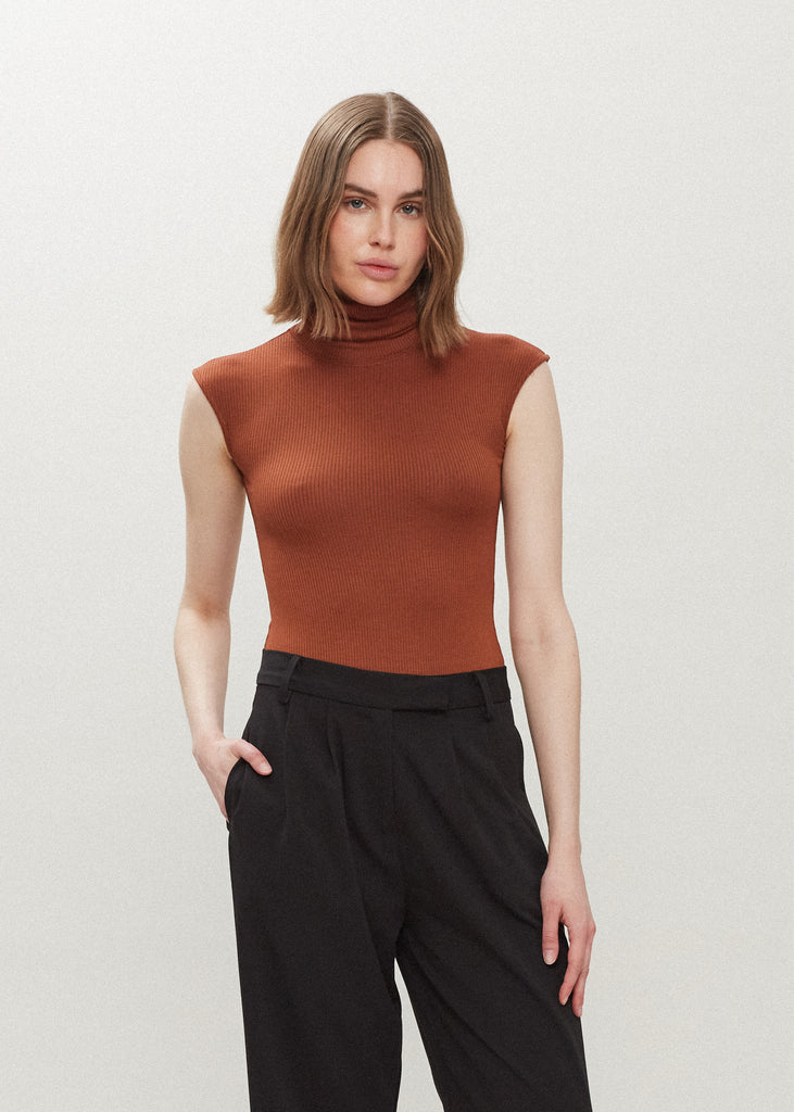 Pecan Penny Bodysuit This buttery soft sleeveless ribbed turtleneck bodysuit showcases a sleek silhouette for a versatile wardrobe staple. *For sanitary reasons, bodysuits are finale sale.
