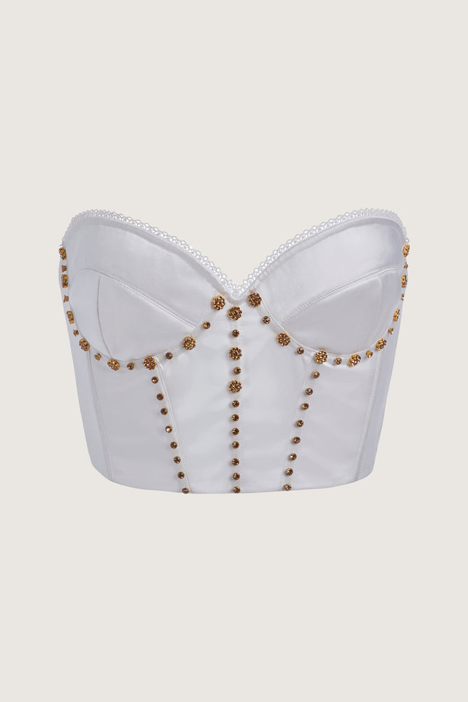 White Petra Corset Boasting a vintage-inspired silhouette, the Petra Corset is crafted with hand-applied gold-and-crystal flower hardware, boning, and underwire. It features lightly lined cups for superior support and a low back with an adjustable hook-and-eye closure, ending at the natural waist. Handmade in India.This item is FINAL SALE.