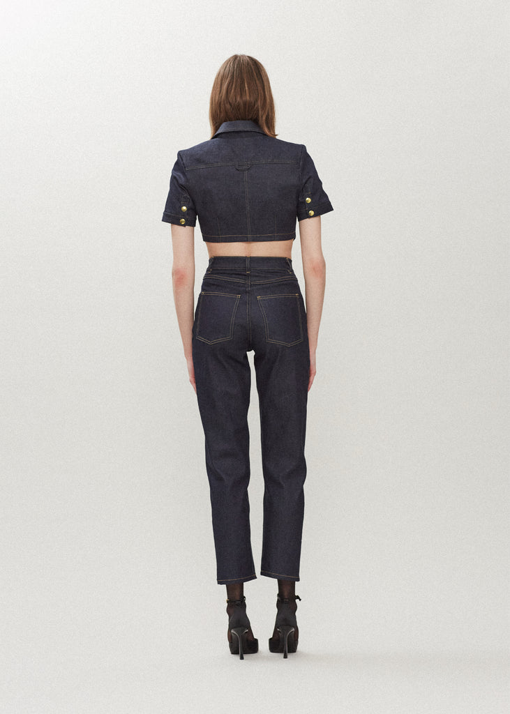 Raw Indigo Quinn Bolero This cropped stretch cotton denim bolero features an asymmetrical curved hem and light shoulder pads for a structured look. 